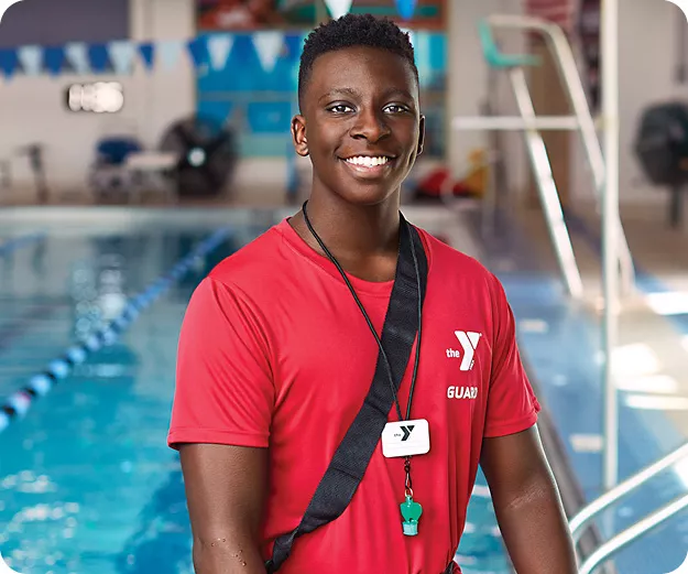 a ymca lifeguard in front of pool