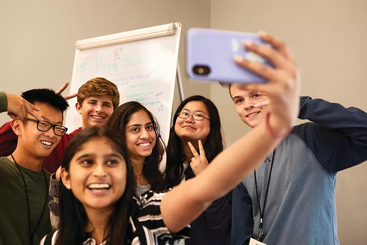 group of teens taking a selfie