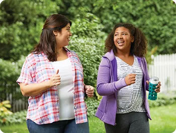 Two woman walking together outdoors