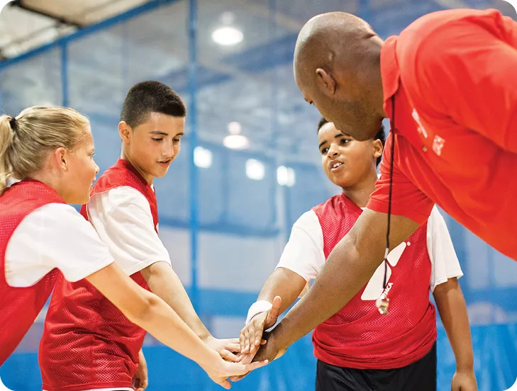 group of kids in a huddle during basketball game
