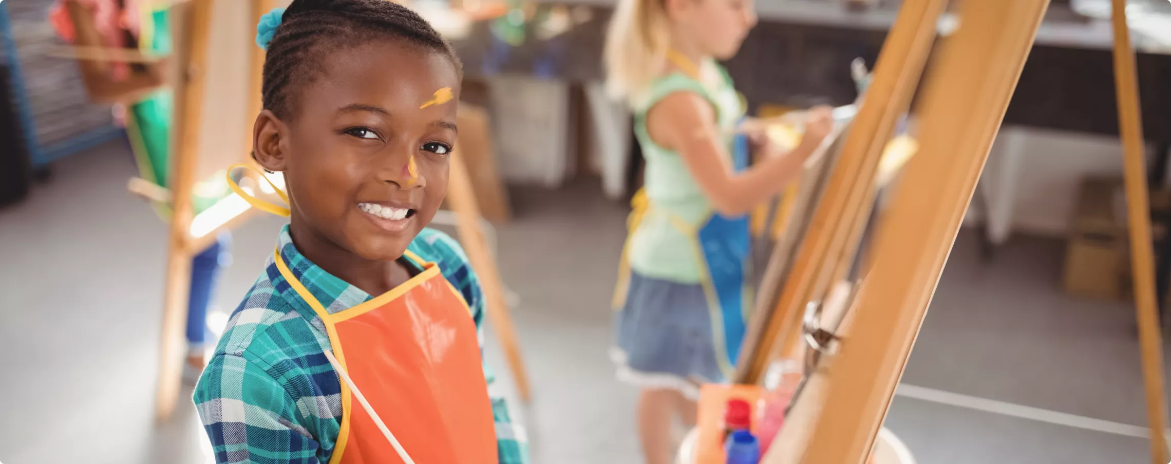 boy painting at an easel