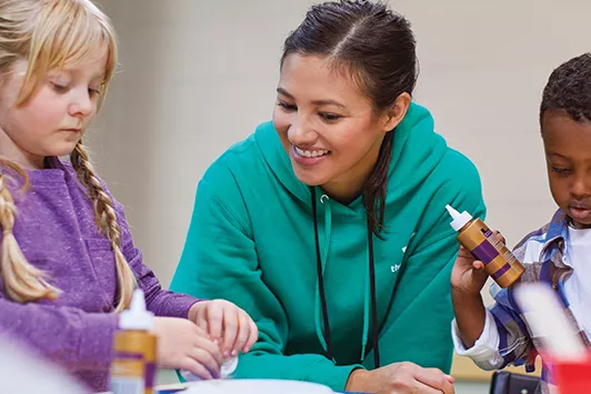children making crafts with teacher