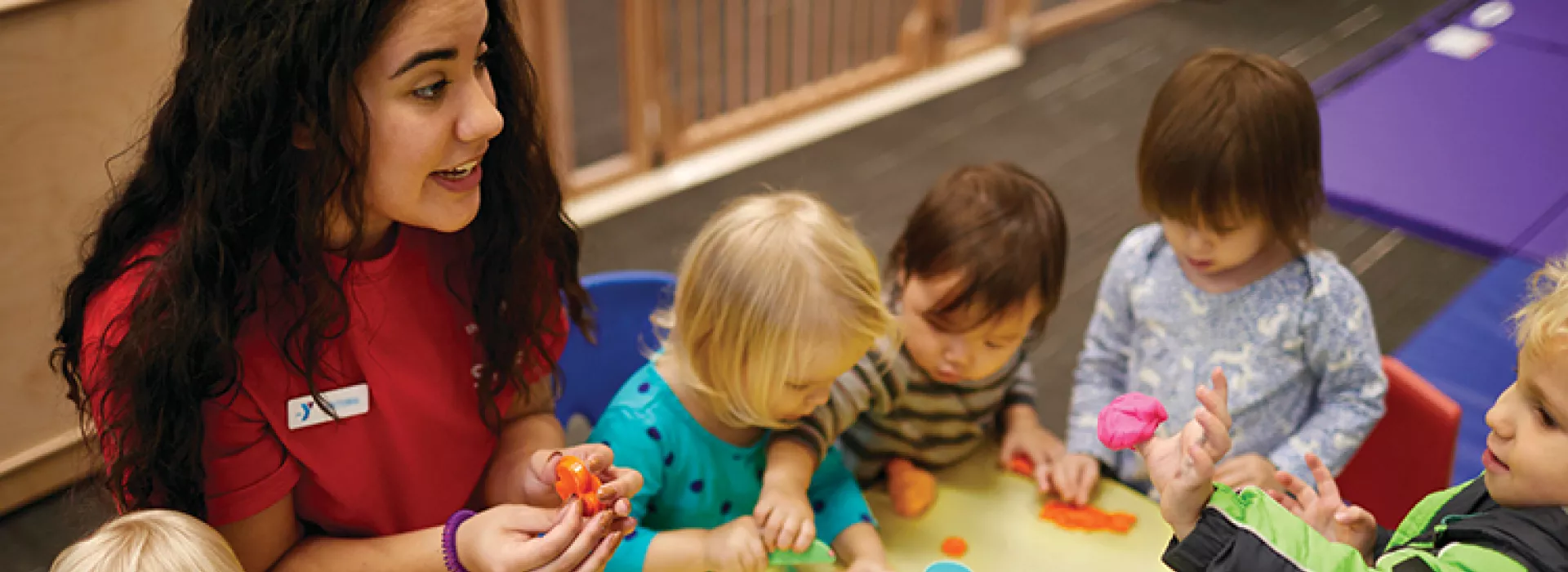 Staff member playing with group of kids