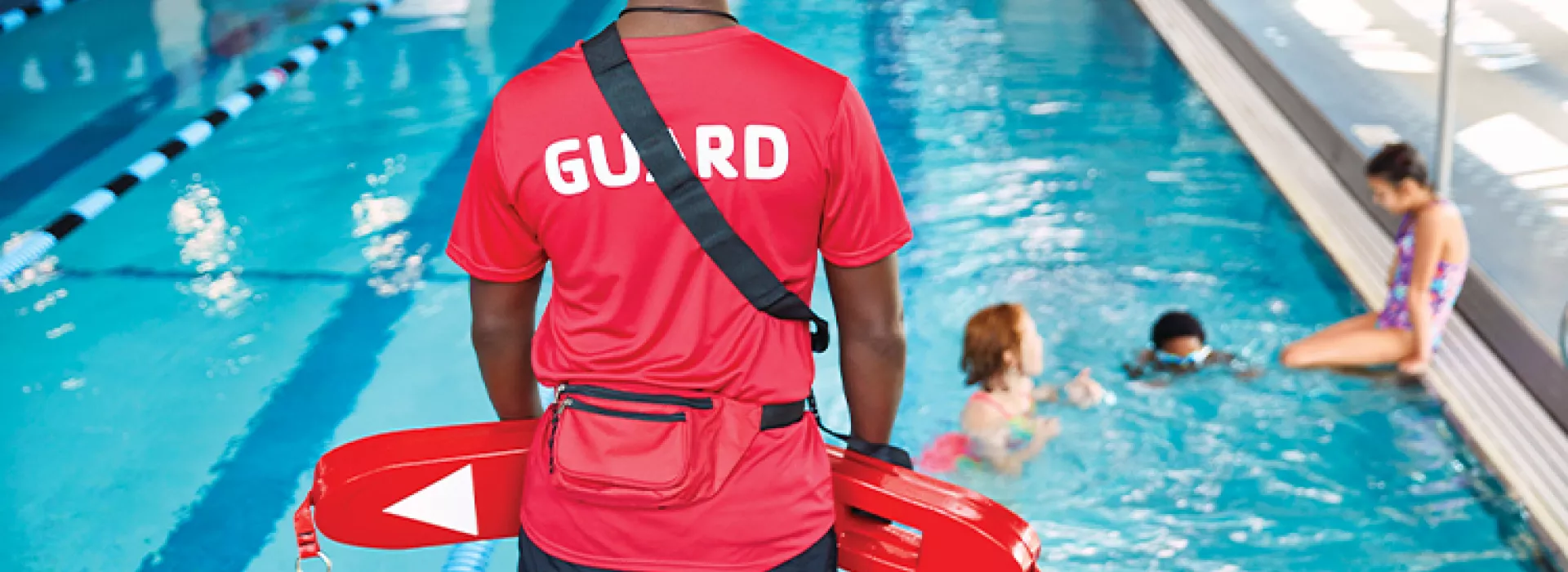 Lifeguard standing near pool