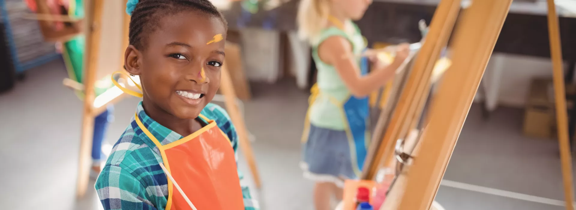 boy painting at an easel