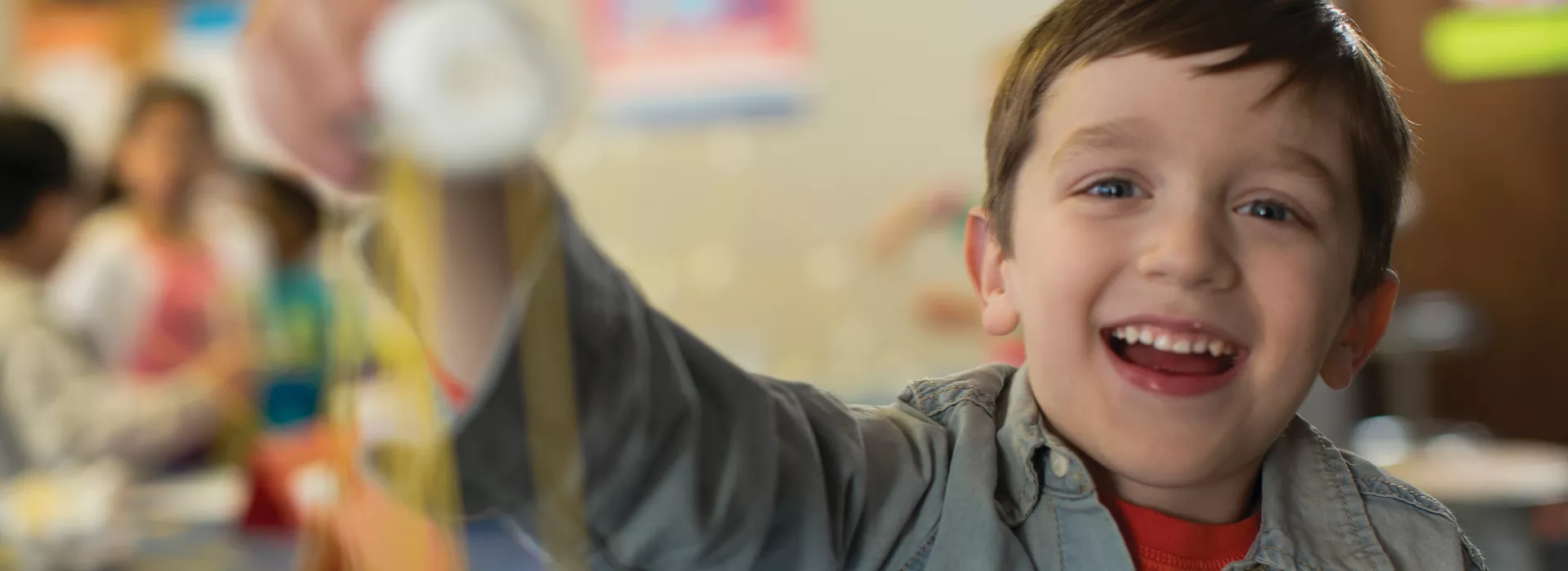 boy holding up stem project