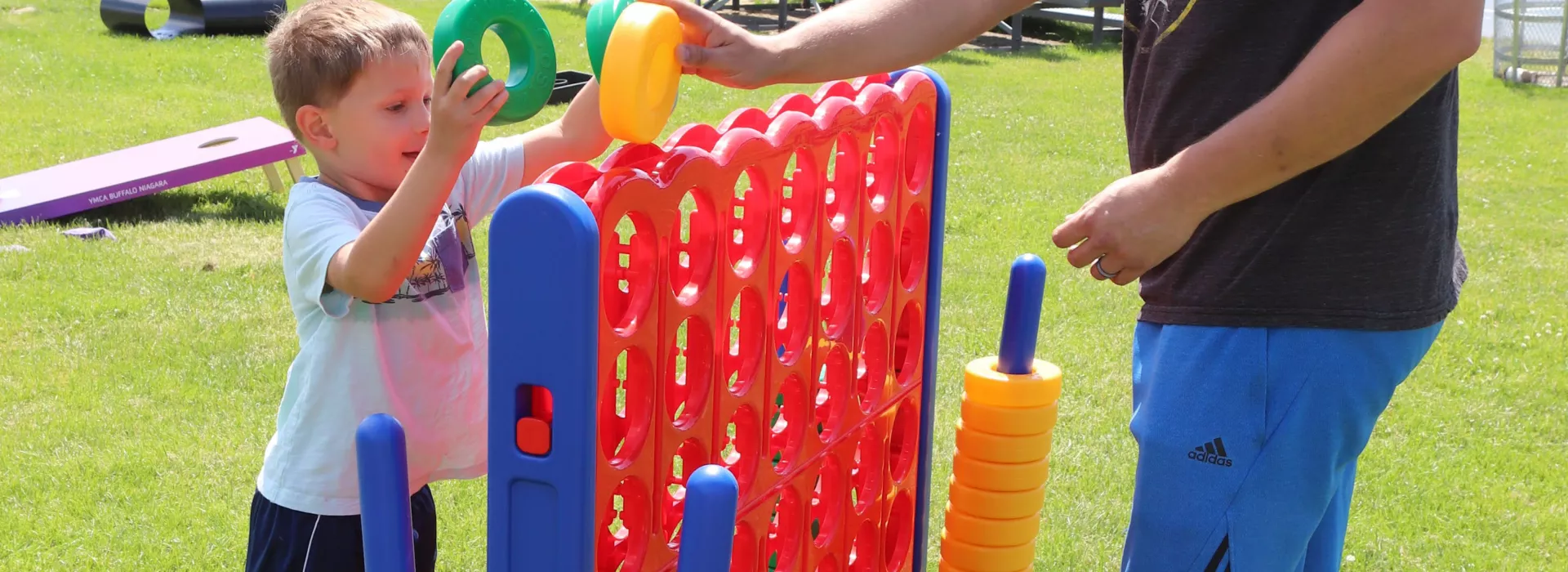 boy and dad playing connect 4