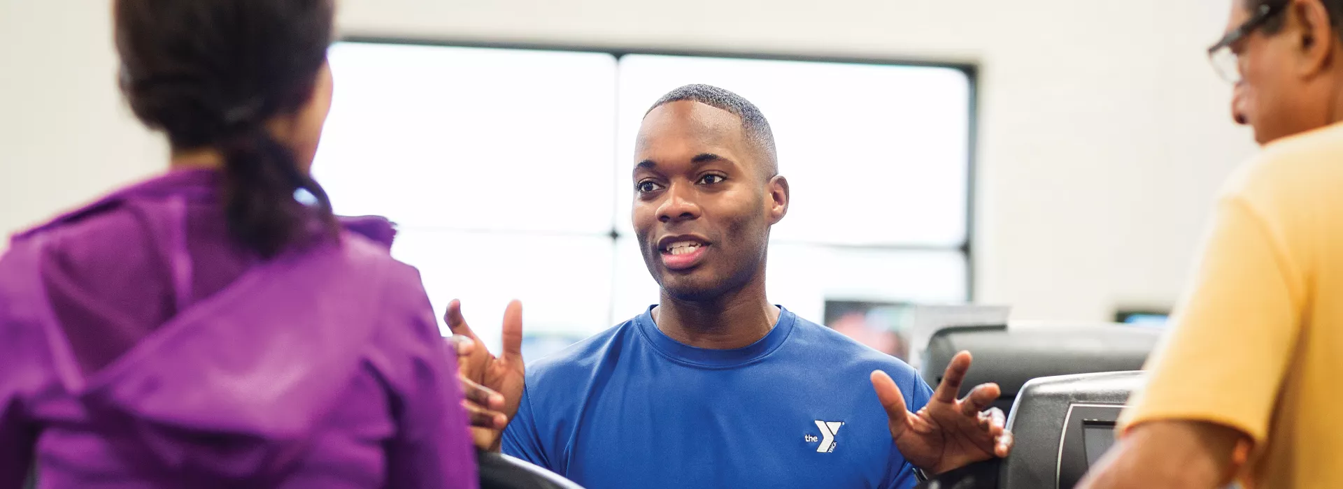 a personal trainer working with two clients