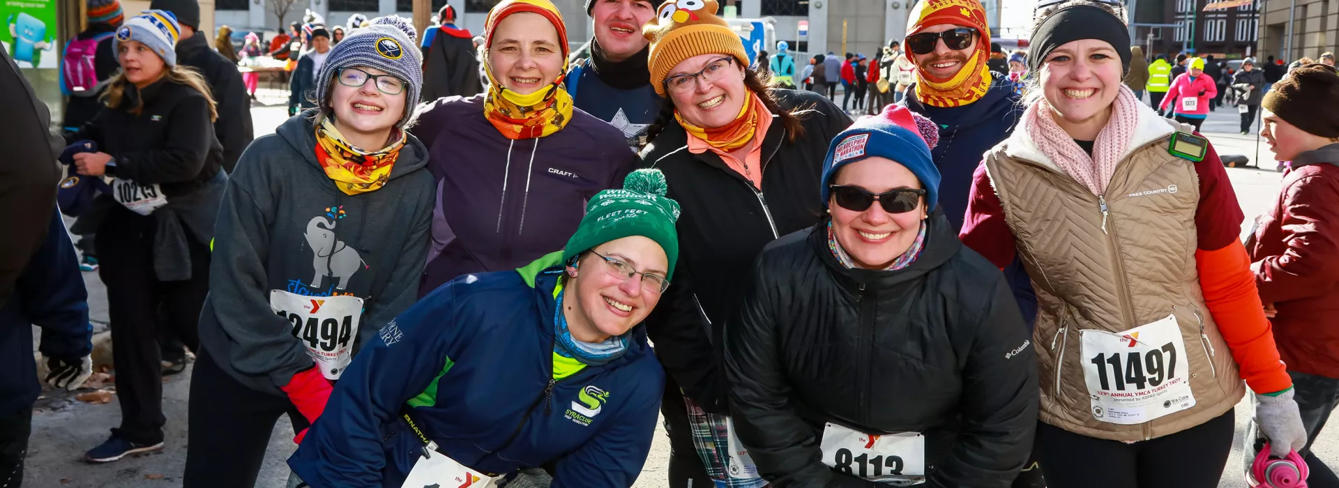 Group of runners posing for photo along race route