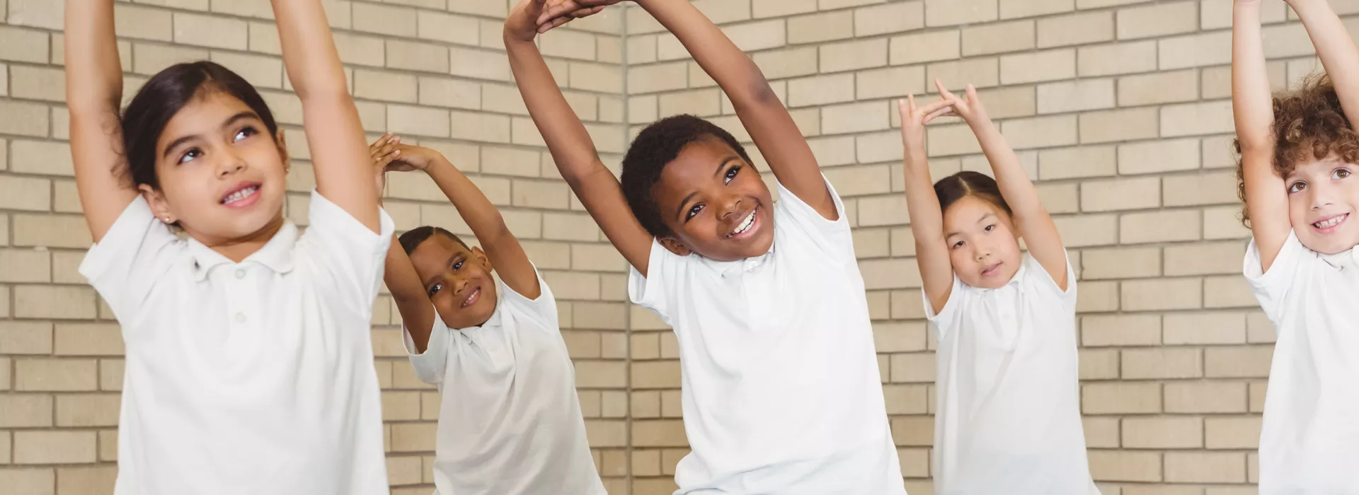group of children stretching in gym class